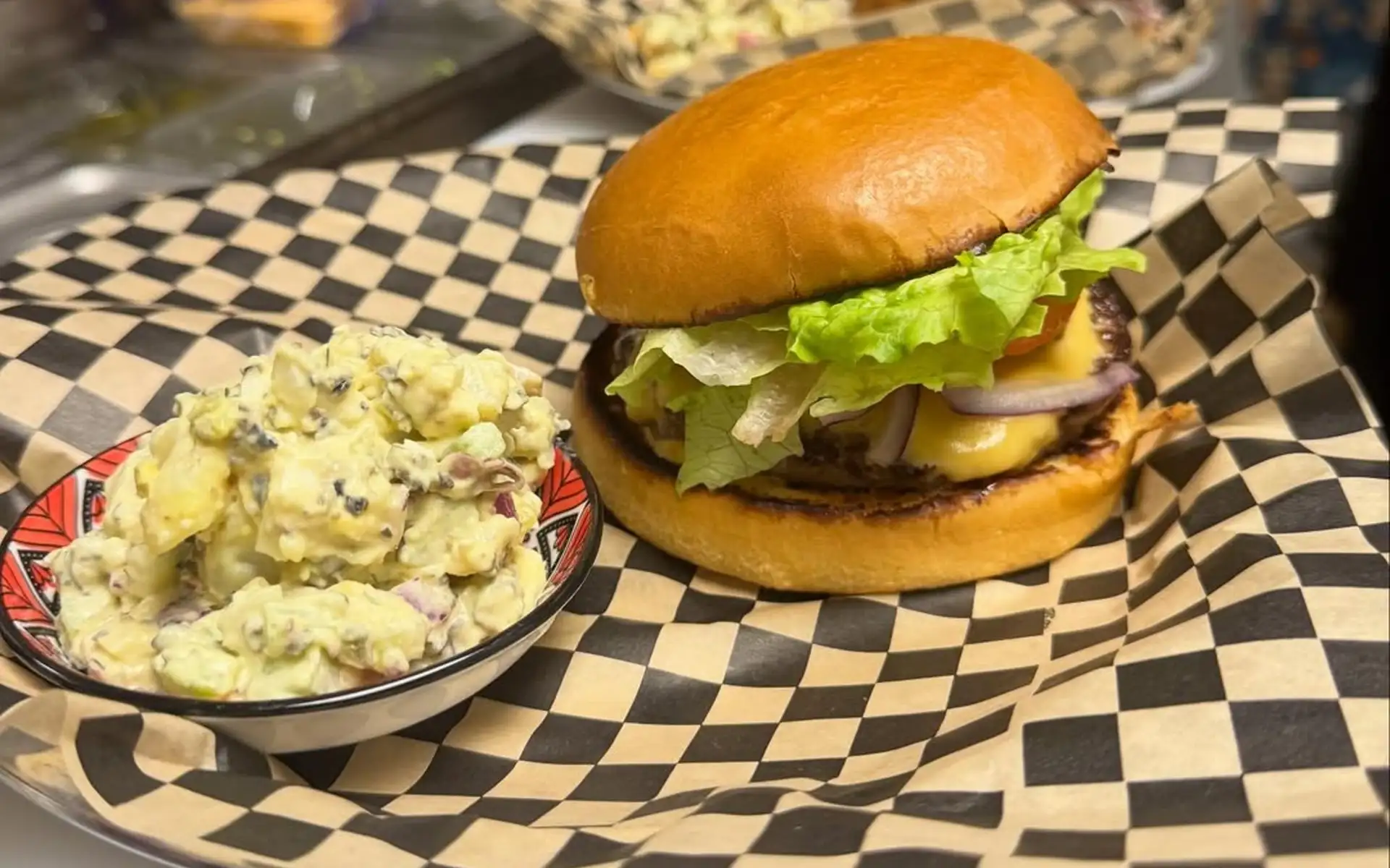 Cheeseburger served with a side of potato salad