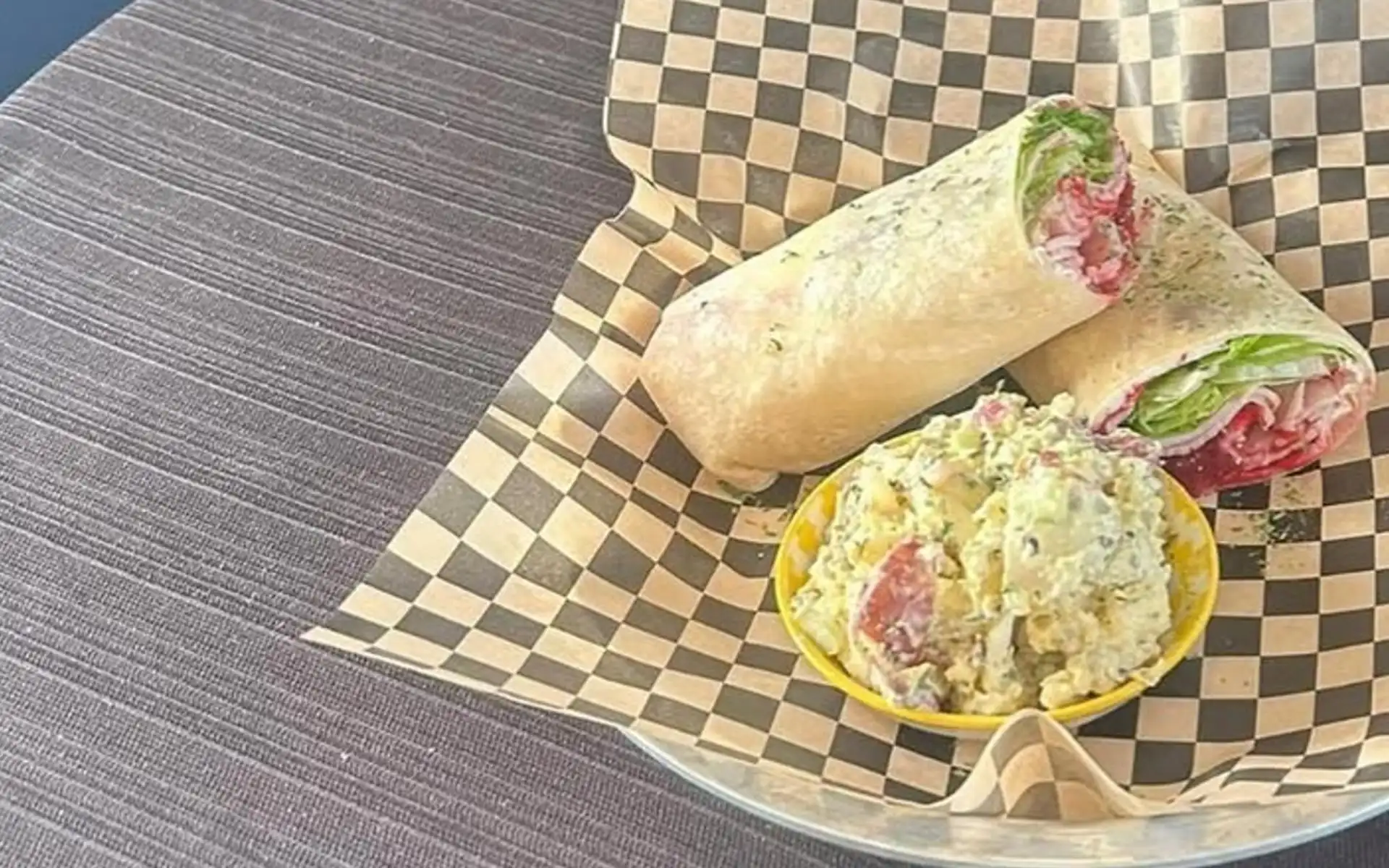 Wrap served with an open-faced side on checkered paper